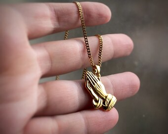 Prayer hands pendant in gold or rhodium (silver) emoticon, non-specific, says “Pray for Peace” on the back, charm only avail too