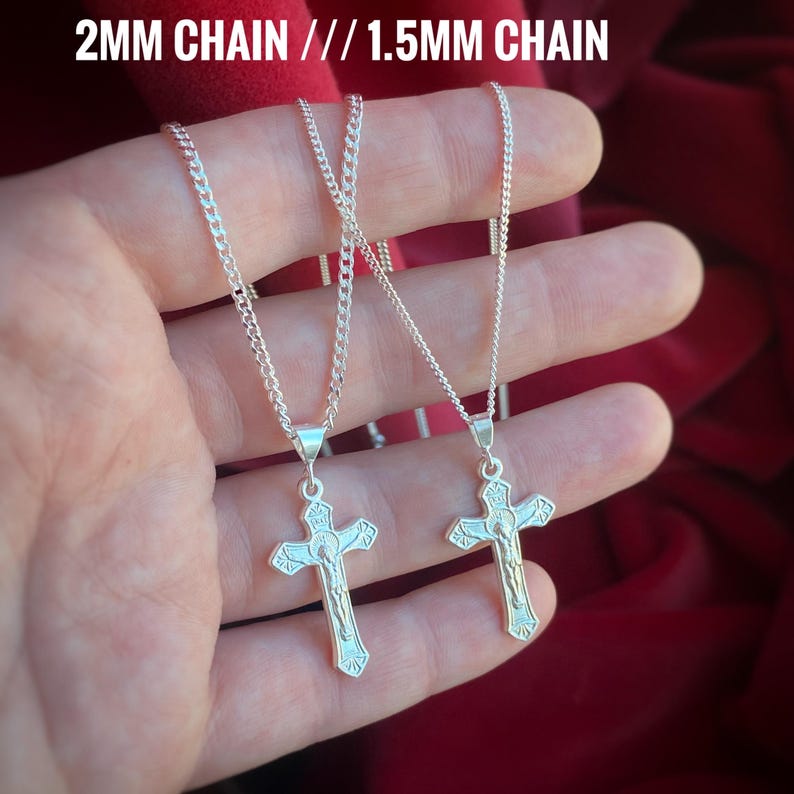 May include: Two silver chains with a silver crucifix pendant. The chain on the left is 2mm thick and the chain on the right is 1.5mm thick.  2MM CHAIN // 1.5MM CHAIN
