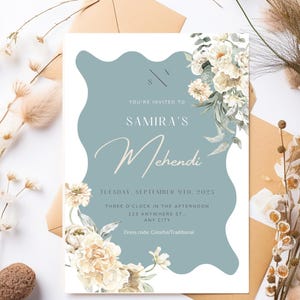 May include: An invitation card for Samira's Mehendi, featuring a light blue wavy design with floral accents. The card includes event details: date, time, and location. Dress code: Colorful/Traditional.