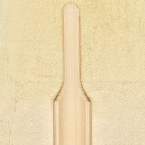 May include: A wooden scoop with a rounded top and a flat bottom. The scoop is made of light brown wood and has a smooth surface.