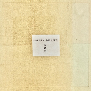 May include: A white label with the text "GOLDEN JOINERY" and the Japanese characters "金継ぎ" on a light yellow textured background.