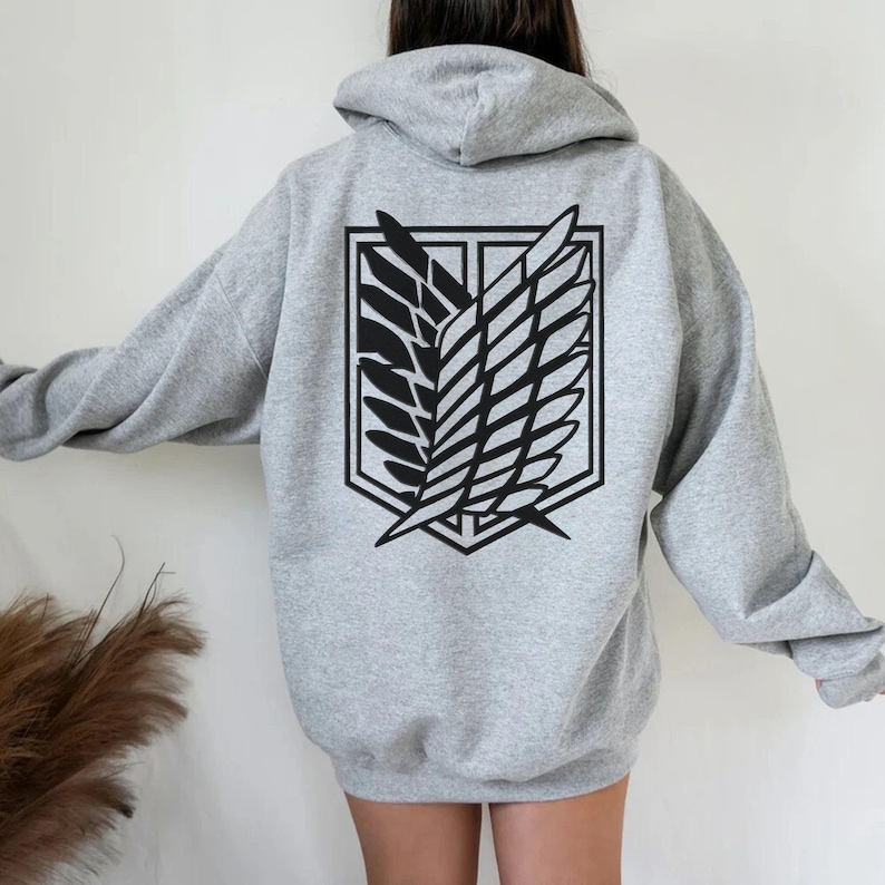May include: A gray hooded sweatshirt with a black graphic of the Attack on Titan Wings of Freedom symbol on the back.