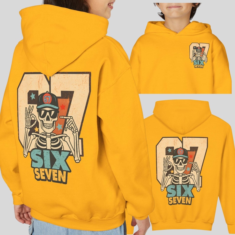 May include: Mustard yellow hoodie featuring a skeleton graphic with the text "SIX SEVEN". The design includes a skeleton wearing sunglasses and a baseball cap. The number "67" is prominently displayed.