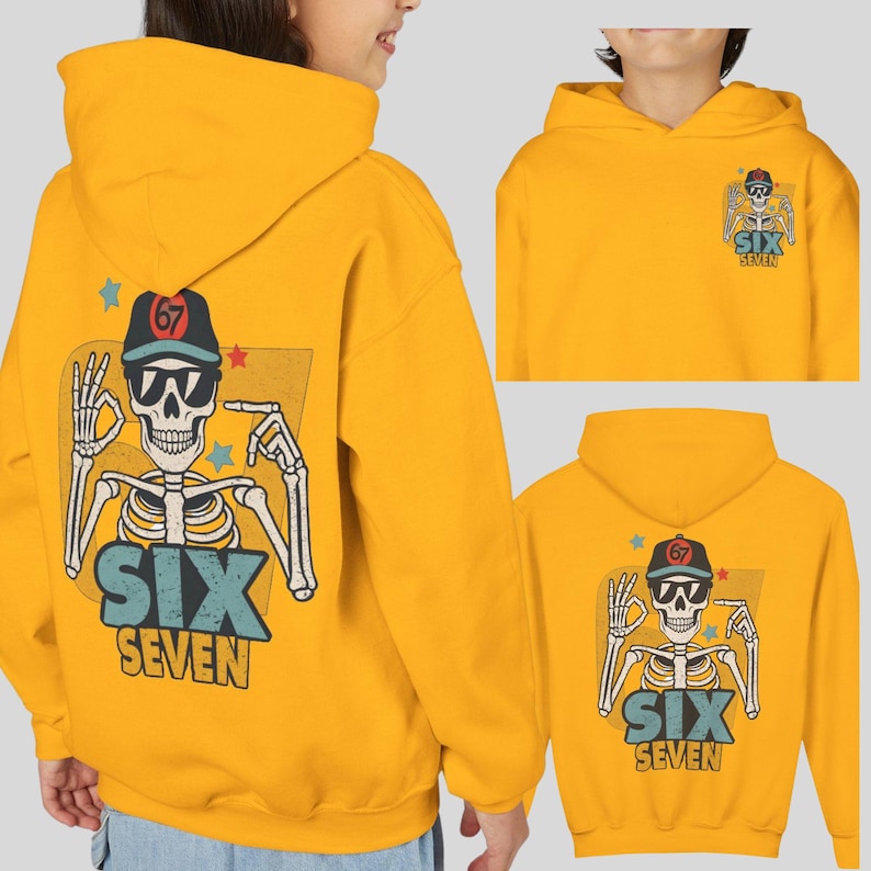 May include: Mustard yellow hoodie featuring a skeleton graphic with sunglasses and a baseball cap. The graphic includes the text "SIX SEVEN" and the number "67". The hoodie has a drawstring hood and a kangaroo pocket.