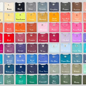 May include: A grid of seventy-two t-shirts displayed in various colors, each featuring a small rectangular label at the neckline. The colors include white, ivory, black, gray, granite, graphite, pepper, espresso, peachy, banana, butter, neon lemon, citrus, mustard, bright orange, neon red orange, neon cantaloupe, terracotta, melon, bright salmon, burnt orange, yam, blossom, peony, crunchberry, neon pink, watermelon, paprika, red, brick, cumin, crimson, chili, orchid, neon violet, violet, boysenberry, berry, grape, vineyard, wine, chambray, hydrangea, chalky mint, lagoon blue, sapphire, washed denim, mystic blue, royal caribbean, periwinkle, flo blue, topaz blue, ice blue, blue jean, denim, midnight, china blue, navy, true navy, bay, sandstone, khaki, island reef, seafoam, light green, island green, grass, emerald, blue spruce, moss, hemp, and sage.