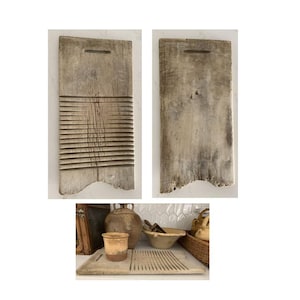 May include: Two antique wooden washboards. One board has horizontal ridges for scrubbing clothes, the other is smooth. Both are rectangular with a handle cutout at the top and a distressed, weathered appearance. The boards are a light, natural wood color.