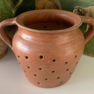 May include: A set of three ceramic mugs with a speckled, matte finish. The mugs are in shades of cream, light gray, and dark gray. Each mug has a simple, minimalist design, perfect for coffee or tea.