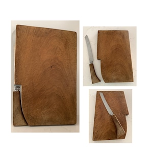 May include: A collection of wooden cutting boards and a knife. The boards are rectangular with a natural wood grain finish. One board has a unique curved edge. The knife has a silver blade and a wooden handle. The items are arranged on a white surface.