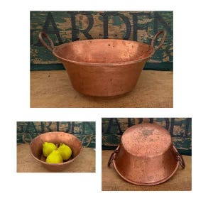 May include: A round copper basin with two side handles, featuring a warm metallic finish. The basin is shown from multiple angles, including one view containing three yellow pears inside the bowl and another view showing the underside.