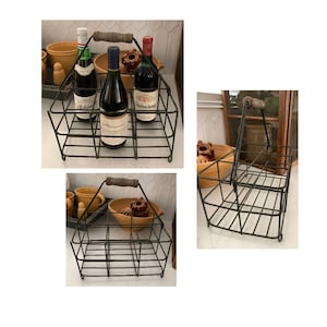 May include: A vintage black metal wine bottle carrier with a wooden handle. The carrier holds six bottles and is shown with wine bottles inside. The carrier is a rustic, farmhouse style.