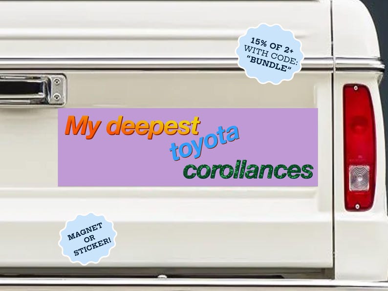 May include: A rectangular bumper sticker or magnet with a light purple background featuring the text My deepest in orange, toyota in blue, and corollances in green. The design is displayed on the white tailgate of a vehicle with red taillights.