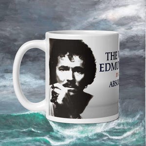 May include: White ceramic mug with a black and white photo of a man with a mustache. The text on the mug reads "The Works" by Edmund  "Absconded".