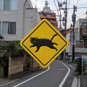May include: A yellow diamond-shaped warning sign with a black silhouette of a cat running across the sign. The sign reads "Beware of Cat".