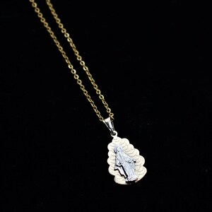 K&ouml;nnte beinhalten: Eine goldene Kettenkette mit einem zweifarbigen Anh&auml;nger, der eine Darstellung der Jungfrau Maria zeigt.