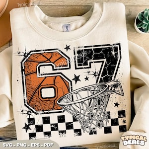 May include: Cream-colored sweatshirt featuring a distressed basketball graphic with the number 67, a basketball, and a net. The design includes black stars and a checkered pattern. The text "Typical Deals" is visible.