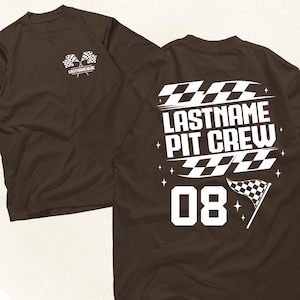 May include: A brown t-shirt with a racing theme. The front features crossed checkered flags and the text "LASTNAMEHERE". The back displays "LASTNAME PIT CREW" with the number "08" and a checkered flag.