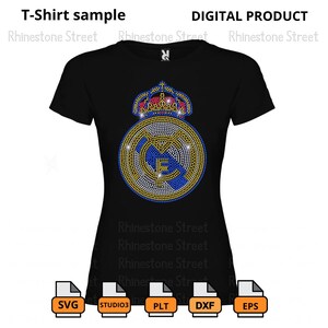 May include: A black t-shirt featuring a rhinestone design of the Real Madrid football team logo. The logo includes a crown, a football, and the team's initials.
