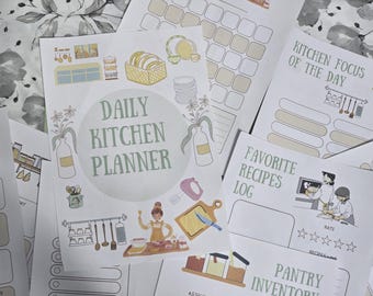 May include: A collection of printed kitchen planner pages. The central page reads "Daily Kitchen Planner" with illustrations of kitchen tools and food. Other pages include "Kitchen Focus of the Day," "Favorite Recipes Log," and "Pantry Inventory."