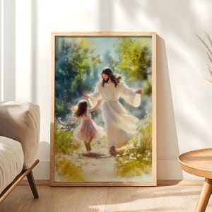 May include: A framed print shows a figure in white robes with open arms, greeting a young girl in a pink dress. The artwork is set in a natural, sunlit environment with a wooden frame, creating a sense of peace and serenity.
