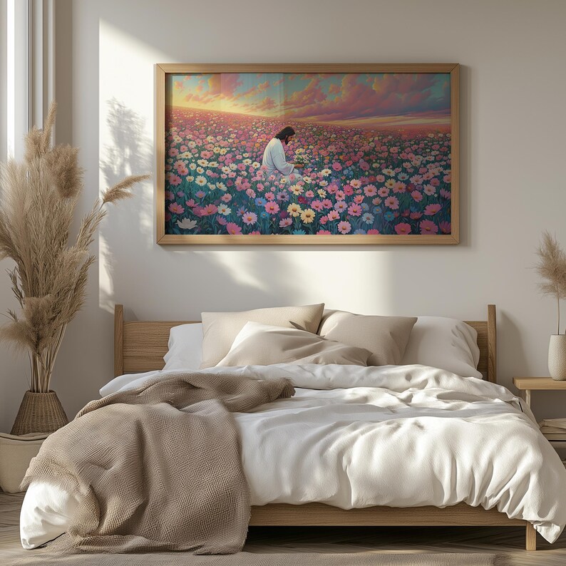May include: A framed painting of a man in a white robe sitting in a field of pink, purple, and white flowers. The sky is a vibrant sunset with pink, orange, and yellow hues.