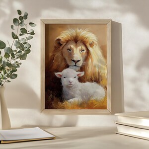 May include: A framed painting of a white lion with a gentle expression, looking down at a white lamb lying in front of it. The background is a warm, golden color.