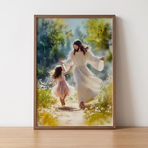 May include: A framed print shows a figure in white robes and a young girl in a pink dress walking together. The artwork is set in a natural, sunlit environment with a path and greenery, creating a peaceful and serene atmosphere.