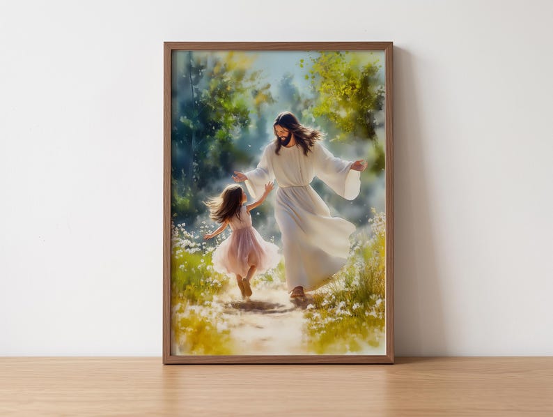 May include: A framed print shows a figure in white robes and a young girl in a pink dress walking together. The artwork is set in a natural, sunlit environment with a path and greenery, creating a peaceful and serene atmosphere.
