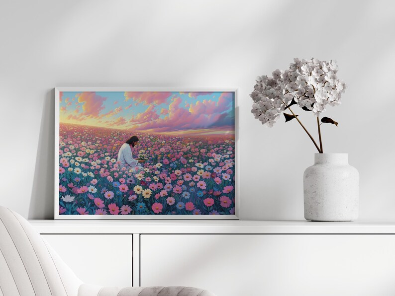 May include: A framed painting depicting a person in white clothing sitting in a field of pink, white, and blue flowers. The sky is a vibrant pink and orange with clouds.