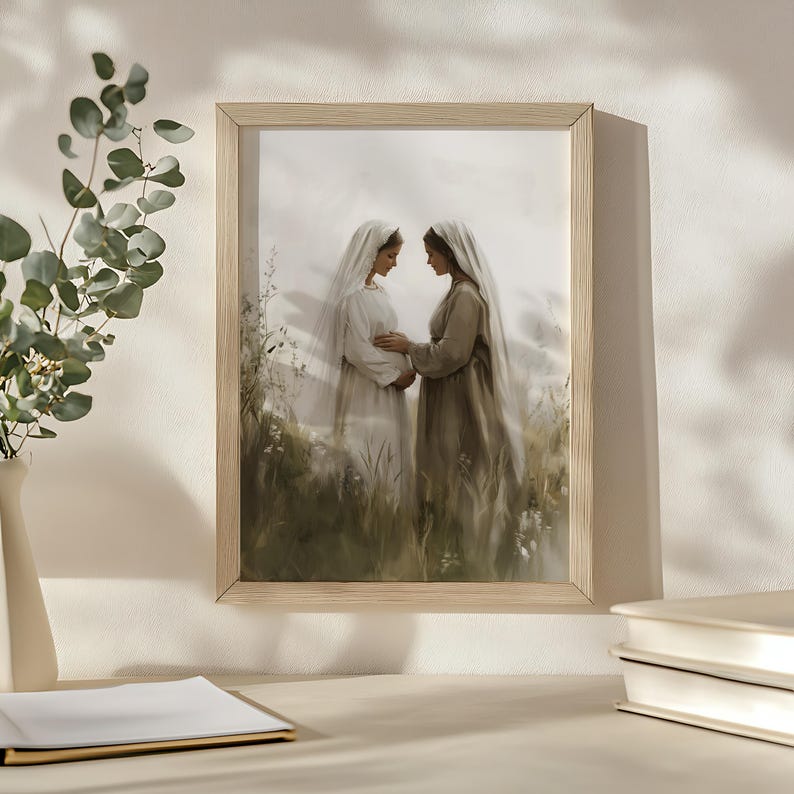 May include: A framed print of a painting depicting two women in long white and brown robes standing in a field of tall grass. The women are looking at each other and holding hands. The painting is done in a soft, muted color palette.