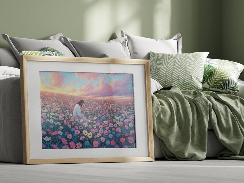 May include: A framed painting of a person sitting in a field of pink, purple, and white flowers. The sky is a soft pink and blue with clouds. The painting is in a light wood frame.