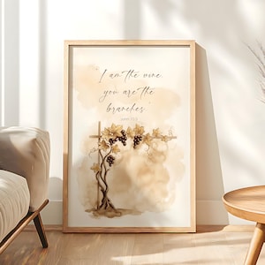 May include: Framed art print featuring a watercolor illustration of a grapevine with the text "I am the vine, you are the branches. John 15:5." The artwork has a neutral color palette with brown and beige tones, and is set in a wooden frame.