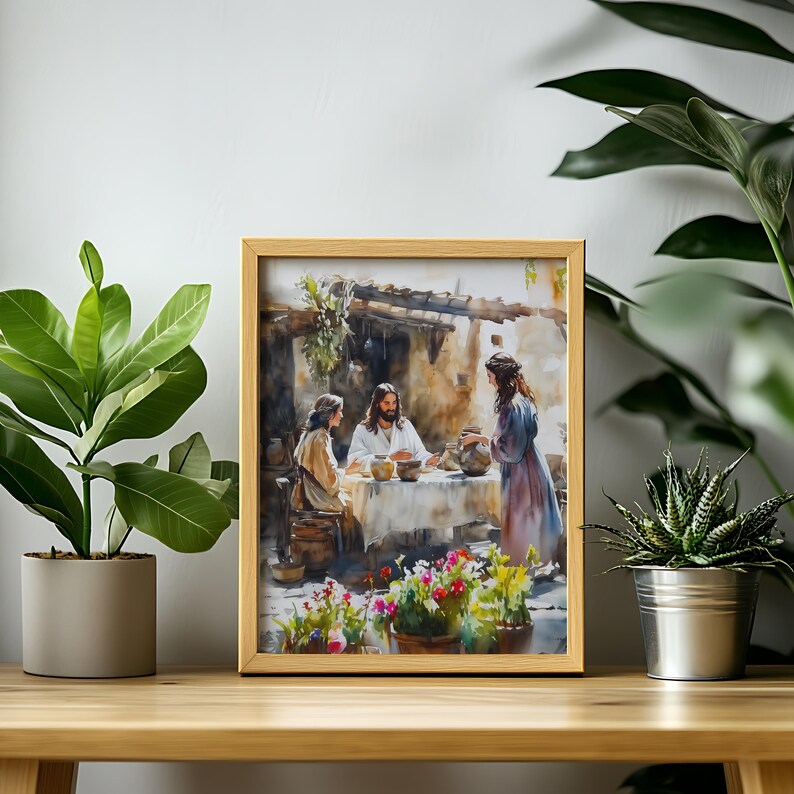 May include: A framed watercolor painting depicting a scene of Jesus with two women. The painting is set in a rustic outdoor setting with a table and flowers. The painting is framed in a light wood frame.