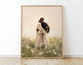 May include: A framed art print depicts two figures embracing in a field of white flowers. One figure, with long brown hair and a white robe, embraces another figure with dark curly hair. The artwork has a soft, warm color palette.