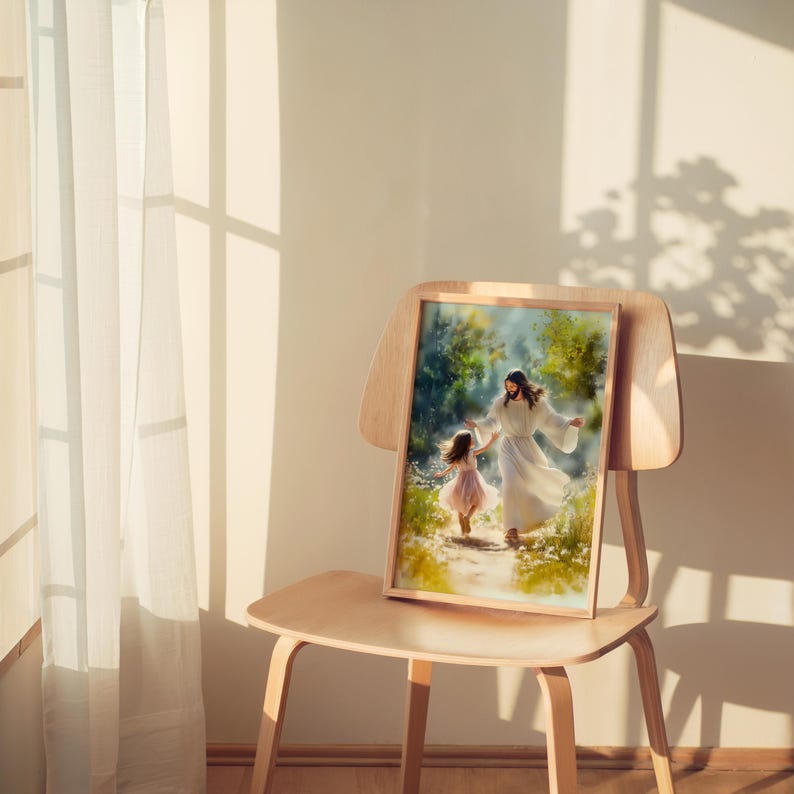 May include: A framed print showing a figure in white robes and a young girl in a pink dress, walking in a green landscape. The artwork is displayed on a wooden chair, with soft lighting. The image has a warm, inviting feel.