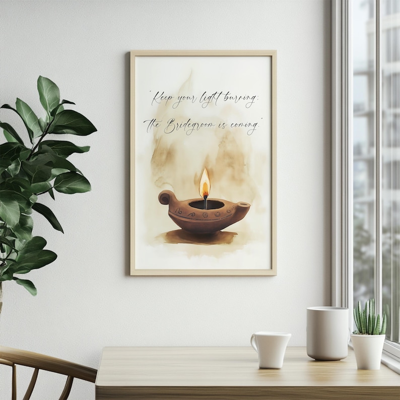 May include: A framed print featuring a watercolor illustration of a brown oil lamp with a lit flame. The artwork includes the text "Keep your light burning. The Bridegroom is coming." The print is displayed on a wall near a window.