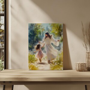 May include: A canvas print showing a figure in white robes with outstretched arms, walking towards a young girl in a pink dress. The background features a path through a field of white flowers and green foliage, creating a serene and uplifting scene.