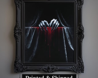May include: A framed artwork with a gothic theme. The image features a pair of hands with long, sharp nails dripping with red liquid. The hands are positioned above a dark surface, with a black background. The frame is ornate and black.