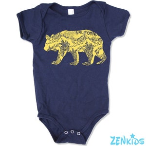 May include: Navy blue baby bodysuit with a yellow bear graphic. The bear design is filled with a mountain and forest scene and the word "CALIFORNIA" is printed above the bear's back.