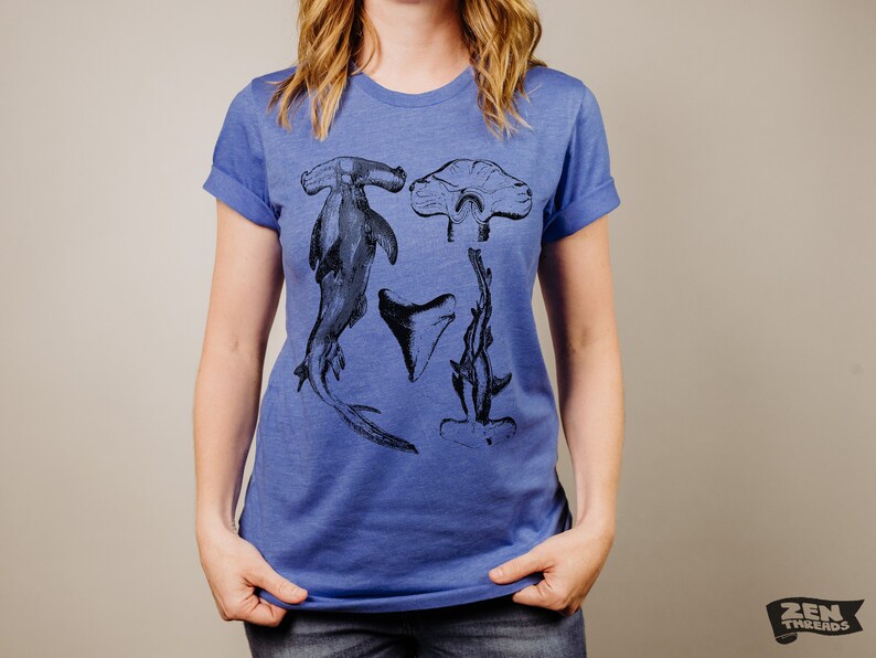 May include: A royal blue t-shirt with a black and white graphic print of hammerhead sharks and a shark tooth.