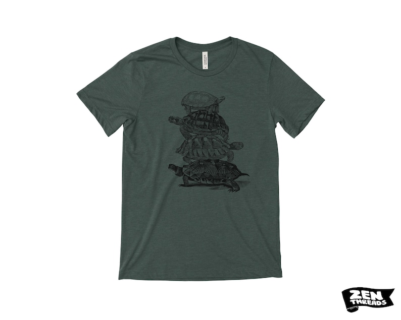 May include: Dark green t-shirt with a black illustration of four turtles stacked. The shirt has a crew neck and short sleeves. The brand "ZEN THREADS" is printed in black on a white background.