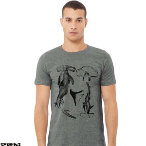 May include: A heather grey t-shirt with a black and white graphic print of hammerhead sharks.