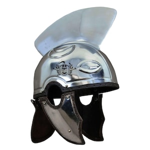 May include: A silver Roman helmet with a crest and a leather chin strap. The helmet has a decorative design on the front.