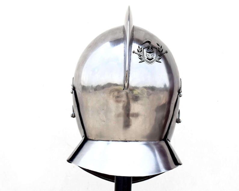 May include: A silver helmet with a pointed top and a decorative crest on the front. The helmet has a visor that can be raised or lowered.