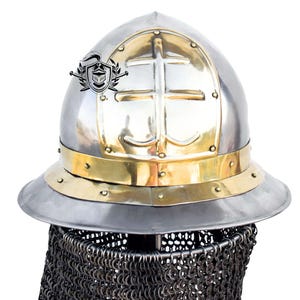 May include: A silver helmet with a brass band and a cross design on the front. The helmet has a chainmail aventail attached.