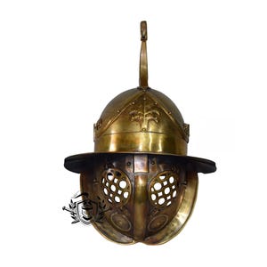 May include: A gold gladiator helmet with a face mask and a plume on top. The helmet has a decorative design on the top and a mesh face mask.