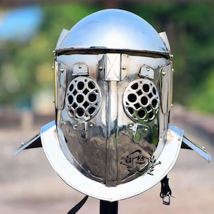 May include: A silver Roman gladiator helmet with a mesh face guard and a decorative crest on the top.