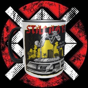 May include: White ceramic mug with a black handle. The mug features a black and white illustration of a skeleton skateboarding on a car with the text "STATIC 13" and "FILL IN THE SILENCE" on the mug.