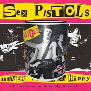 May include: A white ceramic mug with a black rim features a black and white photo of a band member playing a bass guitar. The band's name "Sex Pistols" is printed in black and white on the mug. The mug also features the band's name "Pistols" in yellow letters on a black background.