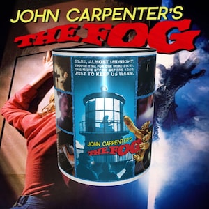 Puede incluir: Una taza de cerámica blanca con borde negro que presenta un collage de imágenes de la película de terror "The Fog" dirigida por John Carpenter. La taza presenta un faro, una mano que se extiende desde la niebla y una escena de la película con el texto "11:55, casi medianoche. Tiempo suficiente para una historia más. Una historia más antes de las 12:00, solo para mantenernos calientes."