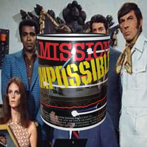May include: A black and red coffee mug with the words "Mission Impossible" in yellow and red letters. The mug has a picture of a car on the bottom half of the mug.